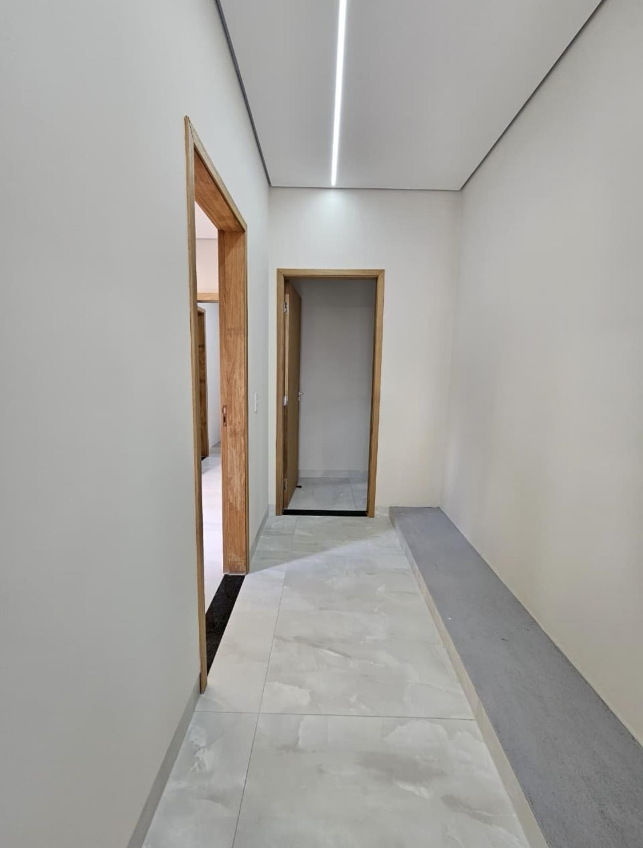 Corredor interno com iluminação linear no teto